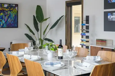 a dining room table with a bottle of wine on it at Mountain Home with Hot Tub, Near WP Resort! in Winter Park