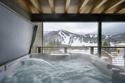 a bath tub with a view of a snow covered mountain at Mountain Home with Hot Tub, Near WP Resort! in Winter Park
