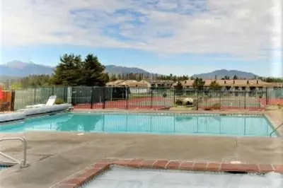 a swimming pool with a fence around it at Pines at Meadow Ridge in Fraser
