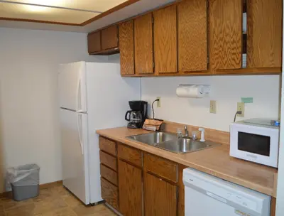a kitchen with a sink and a white refrigerator at Pines at Meadow Ridge in Fraser