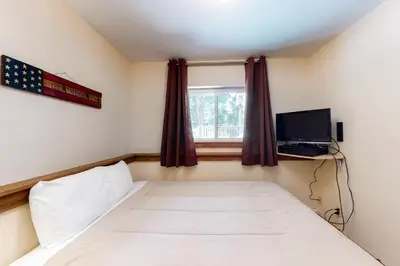 a small bedroom with a bed and a window at Vasquez Vista in Winter Park