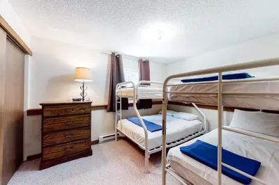 a bedroom with two bunk beds and a dresser at Vasquez Vista in Winter Park