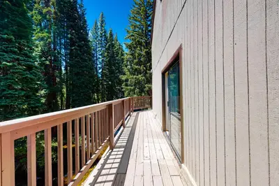 a wooden walkway next to a building with trees at Vasquez Vista in Winter Park