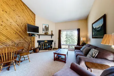 a living room with a couch and a fireplace at Vasquez Vista in Winter Park