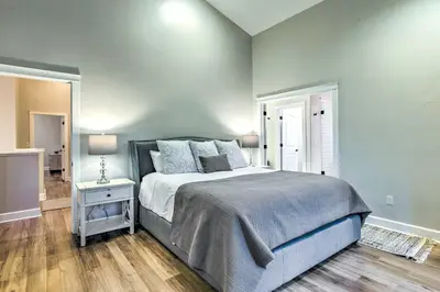 a bedroom with a bed and a table with a lamp at Hot Tub and Outdoor Oasis Luxury Denver Home in Denver