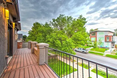 a balcony of a house with a fence and a street at Hot Tub and Outdoor Oasis Luxury Denver Home in Denver
