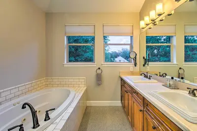 a large bathroom with two sinks and two mirrors at Hot Tub and Outdoor Oasis Luxury Denver Home in Denver