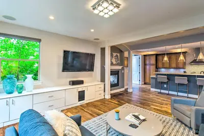 a living room with a couch and a tv at Hot Tub and Outdoor Oasis Luxury Denver Home in Denver