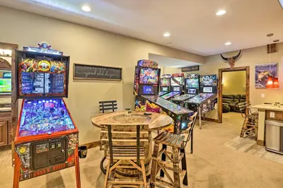a room filled with lots of video games at Game Room and Hot Tub Luxe Grand Lake Retreat! in Grand Lake