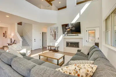 a living room with a couch and a fireplace at Furnished Deck and Hot Tub Chic Granby Home! in Granby
