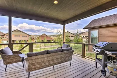 a screened in porch with a couch and a grill at Furnished Deck and Hot Tub Chic Granby Home! in Granby