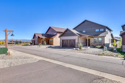 a row of houses on a street at Furnished Deck and Hot Tub Chic Granby Home! in Granby