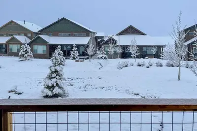 a yard covered in snow with houses at Furnished Deck and Hot Tub Chic Granby Home! in Granby