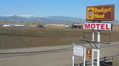 a sign for a motel on the side of a road at Budget Host Exit 254 Inn in Loveland