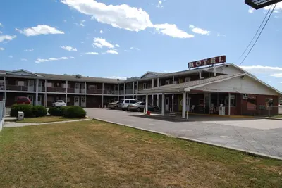 an empty parking lot in front of a hotel at Budget Host Exit 254 Inn in Loveland