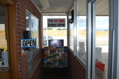 a front door of a hot store with a sign at Budget Host Exit 254 Inn in Loveland