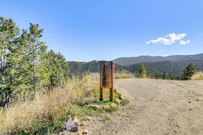 a sign on the side of a dirt road at The View at Mountain Retreat By Red Rocks and Golden in Evergreen