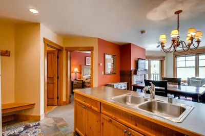 a kitchen with a sink and a living room at The Springs Condominiums by Vail Resorts in Keystone