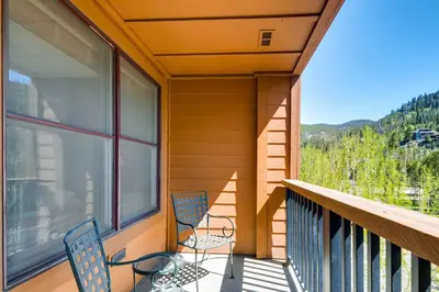 two chairs on a balcony with a view of the mountains at The Springs Condominiums by Vail Resorts in Keystone