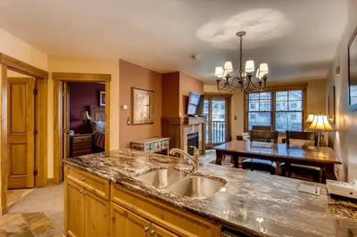 a kitchen with a sink and a table in a room at The Springs Condominiums by Vail Resorts in Keystone