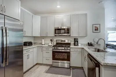 a kitchen with white cabinets and a stainless steel refrigerator at Clearwater Lofts by Vail Resorts in Keystone