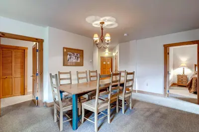 a dining room with a wooden table and chairs at Expedition Station Condos by Vail Resorts in Keystone