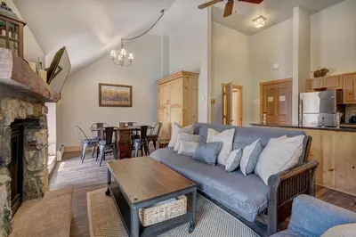 a living room with a couch and a table at Expedition Station Condos by Vail Resorts in Keystone