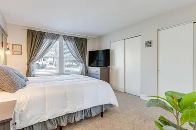 a bedroom with a bed and a large window at 6 Mi to Dtwn Arvada Home with Hot Tub and Yard in Arvada