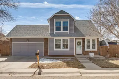 a house with a parking meter in front of it at 6 Mi to Dtwn Arvada Home with Hot Tub and Yard in Arvada