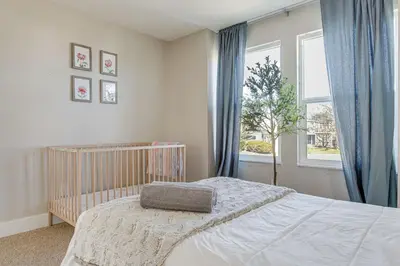 a bedroom with a bed and a large window at 6 Mi to Dtwn Arvada Home with Hot Tub and Yard in Arvada