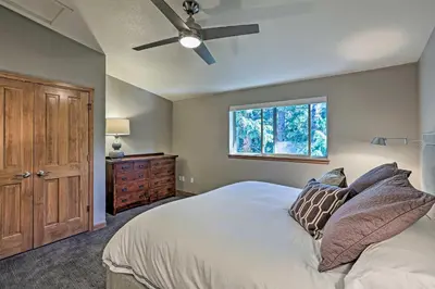 a bedroom with a bed with a ceiling fan and a window at Walk to Main St Frisco Condo with Furnished Deck in Frisco