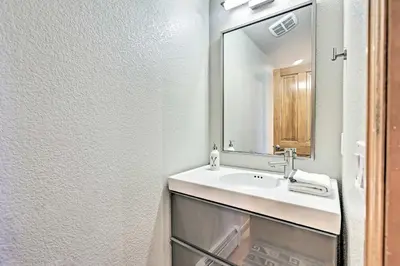 a bathroom with a sink and a mirror at Walk to Main St Frisco Condo with Furnished Deck in Frisco