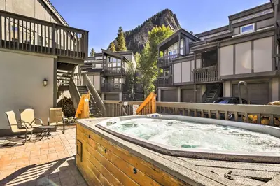 a hot tub in the middle of a courtyard with buildings at Walk to Main St Frisco Condo with Furnished Deck in Frisco