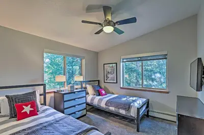 a bedroom with two beds and a ceiling fan at Walk to Main St Frisco Condo with Furnished Deck in Frisco