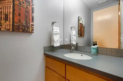 a bathroom with a sink and a mirror at Sleek Home near Old Town with Rooftop Hot Tub & Mtn Views in Fort Collins