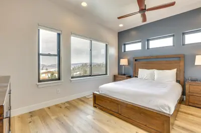 a bedroom with a large bed and windows at Sleek Fraser Townhome Less Than 8 Mi to Winter Park! in Fraser