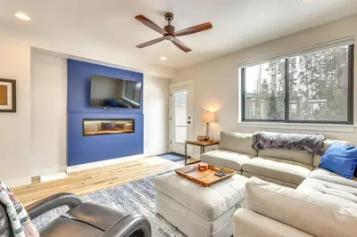 a living room with a couch and a ceiling fan at Sleek Fraser Townhome Less Than 8 Mi to Winter Park! in Fraser