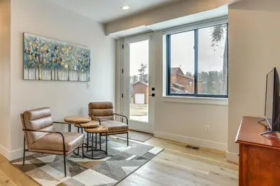 a living room with a table and two chairs at Sleek Fraser Townhome Less Than 8 Mi to Winter Park! in Fraser
