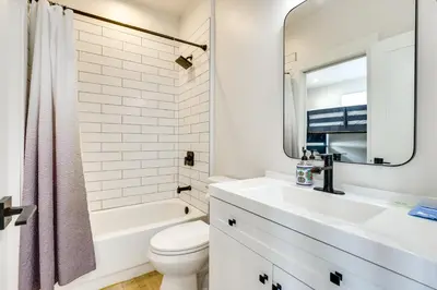a bathroom with a sink and a toilet and a mirror at Sleek Fraser Townhome Less Than 8 Mi to Winter Park! in Fraser