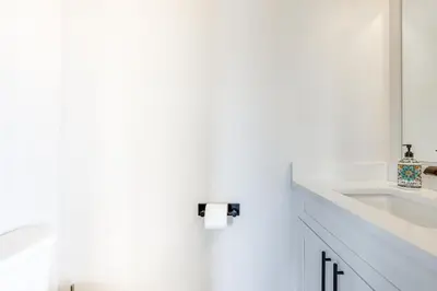 a white bathroom with a sink and a toilet at Sleek Fraser Townhome Less Than 8 Mi to Winter Park! in Fraser