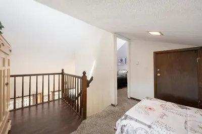 a bedroom with a staircase and a bed in a room at Twin Rivers Vasquez 3 by Stay Winter Park in Fraser