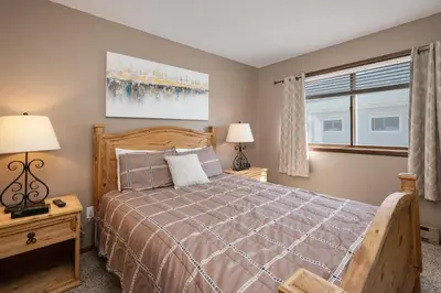 a bedroom with a bed and a window at Twin Rivers Vasquez 3 by Stay Winter Park in Fraser
