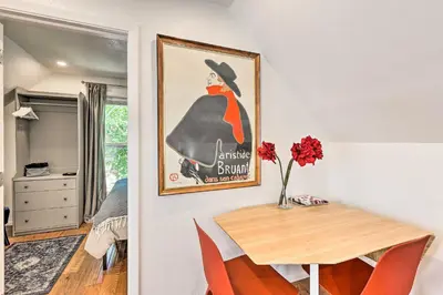a room with a table and a painting on the wall at 2 Mi to Downtown Denver Chic Apartment! in Denver