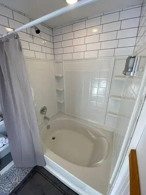 a white bathroom with a tub and a shower at Roof-top stay, king-size bed, views of Loveland in Loveland