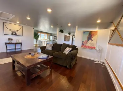 a living room with a couch and a table at Roof-top stay, king-size bed, views of Loveland in Loveland