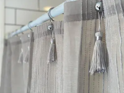 a shower curtain with tassles in a bathroom at Roof-top stay, king-size bed, views of Loveland in Loveland