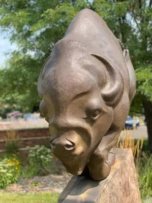 a bronze statue of a face on a rock at Roof-top stay, king-size bed, views of Loveland in Loveland