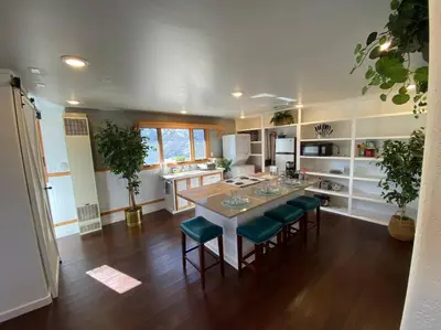 a kitchen with a table and some green chairs at Roof-top stay, king-size bed, views of Loveland in Loveland