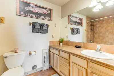 a bathroom with a toilet and a sink at Condo Near Winter Park Resort and Steps From Shuttle in Fraser