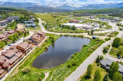 an aerial view of a town with a lake and mountains at Condo Near Winter Park Resort and Steps From Shuttle in Fraser